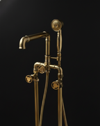Vintage-style brass shower head and hose on a black background