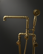 Gold shower head and plumbing system on a dark background